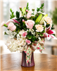 Blushing Beauty Bouquet with pink roses white hydrangea stargazer lilies pink carnations and white filler flowers arranged in a keepsake vase