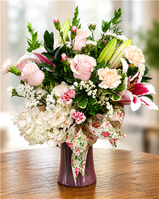 Blushing Beauty Bouquet with pink roses white hydrangea stargazer lilies pink carnations and white filler flowers arranged in a keepsake vase