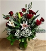 Romantic bouquet with red roses and stargazer lilies in a glass vase arrangement