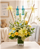 New baby boy bouquet with yellow roses, lilies, white larkspur, carnations, yellow daisies, and baby booties.