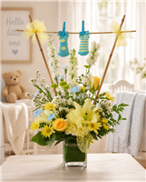 New baby boy bouquet with yellow roses, lilies, white larkspur, carnations, yellow daisies, and baby booties.