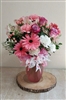 Pink and white mixed bouquet with roses, gerbera daisies, carnations, alstroemeria, and greenery in a frosted vase.