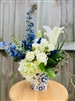 Blue and white bouquet with roses hydrangea lilies and delphinium in a ceramic Delft style vase