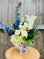 Blue and white bouquet with roses hydrangea lilies and delphinium in a ceramic Delft style vase