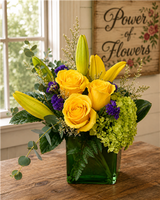 Yellow rose and lily flower arrangement with green hydrangea and purple statice