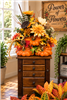 Harvest pumpkin and fall floral arrangement with orange, gold and cream seasonal flowers in League City