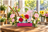 Colorful rose carnation and hydrangea floral gift bag with pink ribbon in League City