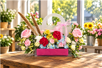 Colorful rose carnation and hydrangea floral gift bag with pink ribbon in League City