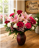 Star Gazer floral arrangement with stargazer lilies, pink carnations, roses, white mini carnations, and pink alstroemeria in a swirl keepsake vase