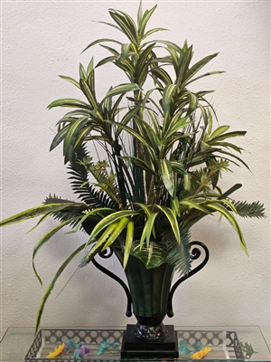 Tall silk dracaena and fern arrangement in a green and black urn.