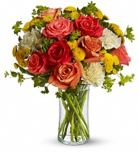 Citrus-Kissed Fall bouquet with orange roses, light yellow carnations, yellow button spray mums, and greens in a slender gathering vase