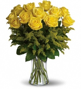 Yellow rose bouquet with solidago and greenery in a glass vase friendship arrangement