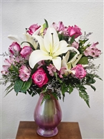 Tall pink and lavender bouquet with roses, lilies, and alstroemeria in a vase arrangement
