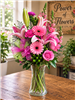 Pink roses and lilies bouquet with snapdragons, gerbera daisies, carnations, and greenery in a clear vase
Bright pink birthday flower arrangement with roses, lilies, and carnations, all-around design.