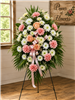 Pink and white funeral standing spray with peach roses, pink carnations and white chrysanthemums