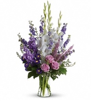 Tall lavender and white bouquet with larkspur, roses, asters, and pink heather in a one-sided design â€“ League City flower delivery