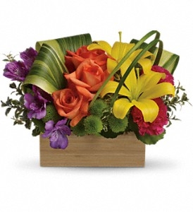 Bright floral arrangement with orange roses, yellow lilies, purple alstroemeria, and carnations in a cedar box.