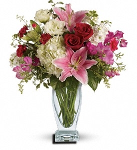 Kensington Garden Bouquet with white hydrangeas, pink oriental lilies, red roses, and pink spring blooms in a clear glass vase
Elegant flower arrangement with hydrangeas, lilies, roses, and seasonal pink flowers, all-around design.