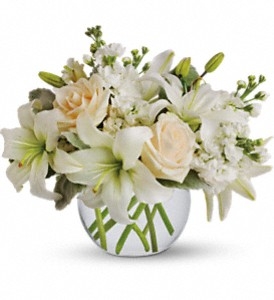 Isle of White arrangement with cream roses, white Asiatic lilies, and stock in a clear glass vase