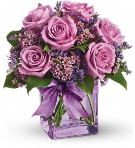 Lavender bouquet with roses waxflower and limonium in a purple cube vase arrangement